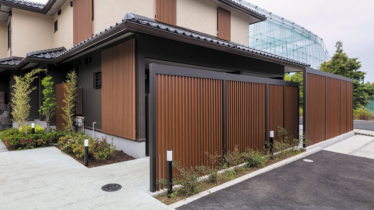 エバー アートウッドの使用事例：落ち着いたカラーのスクリーンと格子材を組み合わせて、重厚感のある建物の印象に
