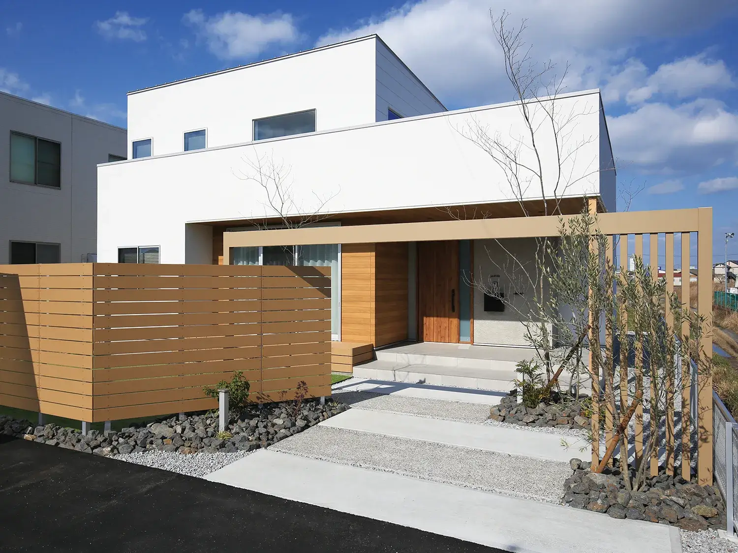 フェンスと調和する、ナチュラルな家の顔