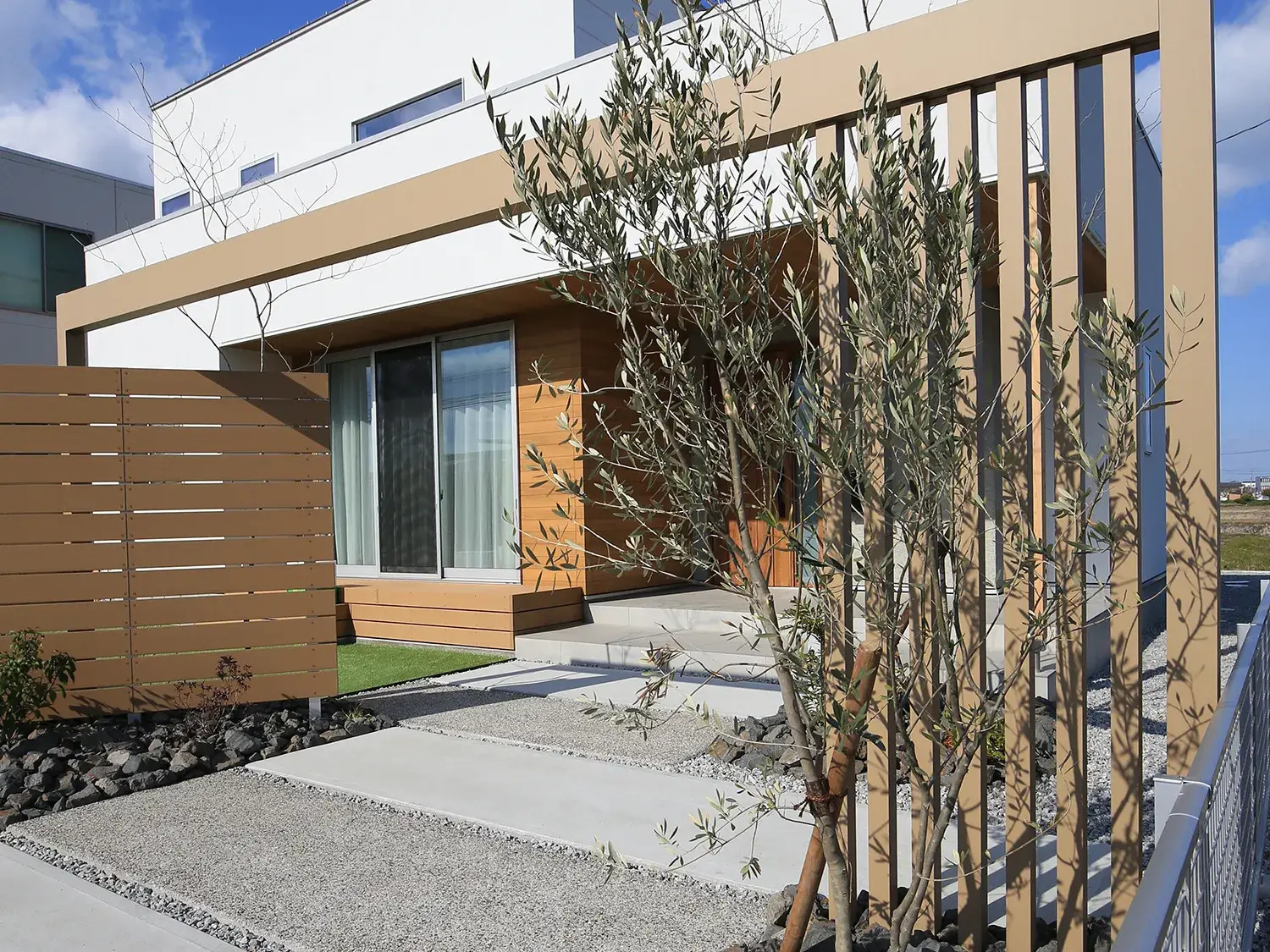 フェンスと調和する、ナチュラルな家の顔